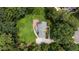 Aerial view of a landscaped home featuring a long drive, large backyard, and a wooden deck at 10721 Marabou Ct, Raleigh, NC 27614