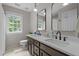 Bathroom featuring double sinks, modern fixtures, and large mirror at 10721 Marabou Ct, Raleigh, NC 27614