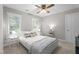 Bright bedroom with a cozy, neutral color scheme and lots of natural light from the large windows at 10721 Marabou Ct, Raleigh, NC 27614