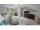 Neutral bedroom offering a television, sitting area, neutral walls and good light from the window at 10721 Marabou Ct, Raleigh, NC 27614