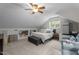 Neutral bedroom offering recessed shelves, a bed, sitting area, and good light from the window at 10721 Marabou Ct, Raleigh, NC 27614