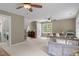 Open bedroom showcases ceiling fans, a seating area, a play area and access to a laundry room at 10721 Marabou Ct, Raleigh, NC 27614