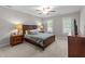 Comfortable bedroom featuring neutral walls, ceiling fan, and carpeted floors at 10721 Marabou Ct, Raleigh, NC 27614