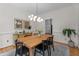 Bright dining room with modern chandelier and wooden dining table with seating for six at 10721 Marabou Ct, Raleigh, NC 27614