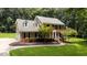 Well-maintained two-story home with brick accents, black shutters, and a lush green lawn at 10721 Marabou Ct, Raleigh, NC 27614