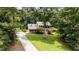 Beautiful two-story home with brick facade and green lawn, surrounded by mature trees at 10721 Marabou Ct, Raleigh, NC 27614
