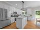 Modern kitchen boasts stainless steel appliances, white cabinetry, granite counters and center island at 10721 Marabou Ct, Raleigh, NC 27614