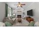 Comfortable living room with a fireplace, built-in bookshelves, and a large flat-screen TV at 10721 Marabou Ct, Raleigh, NC 27614