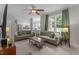 Bright living room featuring neutral furniture, ceiling fan, and view into the spacious, modern kitchen at 10721 Marabou Ct, Raleigh, NC 27614