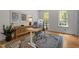 Bright home office featuring hardwood floors, a modern desk setup, and natural light at 10721 Marabou Ct, Raleigh, NC 27614
