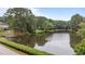 Picturesque pond reflecting surrounding trees and blue sky near a charming gazebo, offering tranquil views at 10721 Marabou Ct, Raleigh, NC 27614