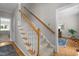 Carpeted staircase with wooden handrail leading to the upper level of the home at 10721 Marabou Ct, Raleigh, NC 27614