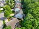 Aerial view of a neatly planned residential neighborhood, complete with landscaped yards and mature trees at 108 Market Cross Ct, Holly Springs, NC 27540
