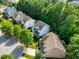Aerial view of well-maintained homes, lush trees and manicured lawns in a quiet neighborhood at 108 Market Cross Ct, Holly Springs, NC 27540