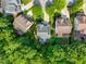 Overhead shot showcasing homes with well-kept lawns and beautiful landscaping in a suburban community at 108 Market Cross Ct, Holly Springs, NC 27540