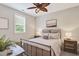 Cozy bedroom with ceiling fan, natural light, and neutral tones creating a relaxing space at 108 Market Cross Ct, Holly Springs, NC 27540