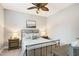 Comfortable bedroom with ceiling fan, natural light, and neutral tones creating a peaceful retreat at 108 Market Cross Ct, Holly Springs, NC 27540