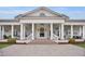 Inviting clubhouse exterior featuring a brick fireplace, spacious porch, and seating arrangements at 108 Market Cross Ct, Holly Springs, NC 27540