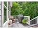 Cozy deck area with chair, grill and view of the surrounding nature at 108 Market Cross Ct, Holly Springs, NC 27540