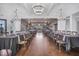 Elegant dining space, perfect for hosting events, with tables set and warm chandelier lighting at 108 Market Cross Ct, Holly Springs, NC 27540