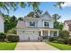 Beautiful exterior of a two-story home featuring a well manicured lawn and two car garage at 108 Market Cross Ct, Holly Springs, NC 27540