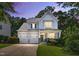 Charming two-story home features a two car garage, manicured lawn and inviting front porch at 108 Market Cross Ct, Holly Springs, NC 27540