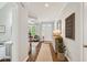 Bright foyer with hardwood floors leads to a cozy living area and features a console table at 108 Market Cross Ct, Holly Springs, NC 27540