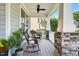 Charming front porch featuring rocking chairs with stone pillars, great for enjoying the outdoors at 108 Market Cross Ct, Holly Springs, NC 27540