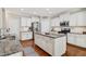 Open kitchen with granite countertops, stainless appliances, and ample cabinetry ensures functionality at 108 Market Cross Ct, Holly Springs, NC 27540