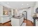 Spacious kitchen with granite countertops, stainless steel appliances, and large center island at 108 Market Cross Ct, Holly Springs, NC 27540