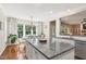 Bright kitchen with granite counters, island, stainless appliances, and eat-in breakfast nook at 108 Market Cross Ct, Holly Springs, NC 27540