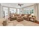 Spacious living room with a large sectional, ottoman, and abundant natural light offer relaxation at 108 Market Cross Ct, Holly Springs, NC 27540