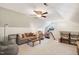 Bright, vaulted ceiling living room featuring a gray sofa and mini fridge, creating a comfortable entertainment space at 108 Market Cross Ct, Holly Springs, NC 27540
