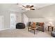 Comfortable living room featuring a vaulted ceiling, cozy seating area, and stylish decor for relaxation and entertainment at 108 Market Cross Ct, Holly Springs, NC 27540