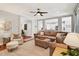 Open-concept living room with plush seating, natural light, and seamless flow to the kitchen for modern living at 108 Market Cross Ct, Holly Springs, NC 27540