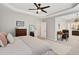 Large bedroom featuring a tray ceiling, ceiling fan, carpet flooring, and ensuite bathroom at 108 Market Cross Ct, Holly Springs, NC 27540