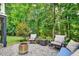 Inviting patio area with comfortable seating, fire pit and view of trees at 108 Market Cross Ct, Holly Springs, NC 27540