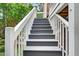 Exterior staircase with decorative steps provides access to outdoor spaces at 108 Market Cross Ct, Holly Springs, NC 27540