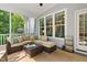 Comfortable screened porch with seating, rug and view of the exterior yard at 108 Market Cross Ct, Holly Springs, NC 27540