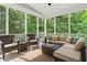 Comfortable screened porch features a ceiling fan and plenty of seating and view of nature at 108 Market Cross Ct, Holly Springs, NC 27540