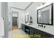 Modern bathroom with double vanity, stylish mirrors, and neutral color palette at 110 Broadleaf Ln, Louisburg, NC 27549