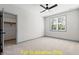 Bright bedroom featuring a ceiling fan, neutral carpet, large window and walk in closet at 110 Broadleaf Ln, Louisburg, NC 27549