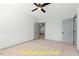 Spacious bedroom with neutral carpet, ceiling fan, with access to other rooms at 110 Broadleaf Ln, Louisburg, NC 27549