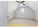 Slanted ceiling bedroom with a ceiling fan and large window at 110 Broadleaf Ln, Louisburg, NC 27549