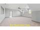 Large bonus room with neutral carpet, lots of light, and gray trim at 110 Broadleaf Ln, Louisburg, NC 27549