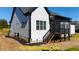 Exterior side view of home showcasing back deck, siding and manicured lawn at 110 Broadleaf Ln, Louisburg, NC 27549