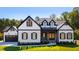 New construction home with black trimmed windows, wood shutters and a two car garage at 110 Broadleaf Ln, Louisburg, NC 27549