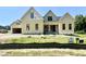 New construction home featuring yellow siding, black window trim, a covered entry, and a two car garage at 110 Broadleaf Ln, Louisburg, NC 27549