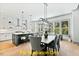 Open concept kitchen featuring a large island, stainless steel appliances, and hardwood flooring at 110 Broadleaf Ln, Louisburg, NC 27549