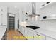 Kitchen features white cabinets, stainless steel appliances, quartz countertops, and a pantry at 110 Broadleaf Ln, Louisburg, NC 27549